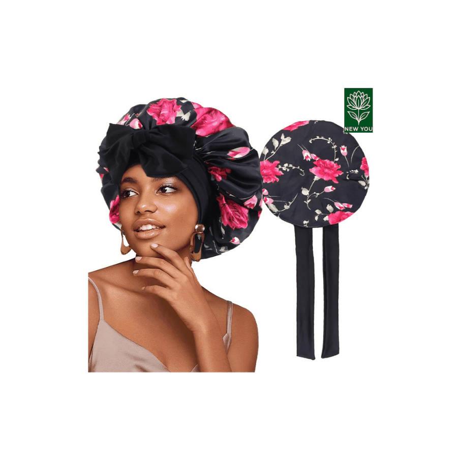 Flower print silky bonnet in black with pink flowers worn by woman and shown flat with long ties for hair protection and style